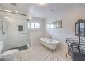 Elegant bathroom featuring a freestanding tub, glass-enclosed shower, classic fixtures, and stylish tile flooring, creating a luxurious retreat at 4170 Ridgecrest Dr, Las Vegas, NV 89121