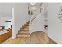 Bright entryway showcases a curved staircase with hardwood floors and an open floor plan at 4330 Flandes St, Las Vegas, NV 89121