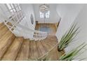 Inviting entryway features a wooden curved staircase with white railing and elegant chandelier at 4330 Flandes St, Las Vegas, NV 89121
