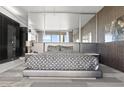 Modern main bedroom featuring a bed with a unique geometric pattern and floor to ceiling windows at 4381 W Flamingo Rd # 922, Las Vegas, NV 89103