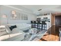Open-concept living and kitchen area with a stylish white sofa and modern bar seating at 4525 Dean Martin Dr # 2001, Las Vegas, NV 89103