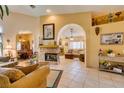Open-concept living room with tile flooring, fireplace, and seamless flow to the dining area at 489 Beaconwood St, Henderson, NV 89052