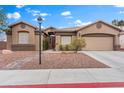 Inviting front exterior with beautiful landscaping, rock garden, and two-car garage, complete with desert landscaping at 5601 Quail Meadow Ct, Las Vegas, NV 89131