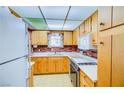 Classic kitchen design with wood cabinets, updated appliances and brick accents at 648 Utah St, Boulder City, NV 89005