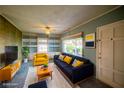 Staged living room with cozy seating, built in bookcases and ample natural light at 648 Utah St, Boulder City, NV 89005