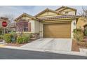Attractive exterior view of a home with a two-car garage and desert landscaping at 7413 Old Compton St, Las Vegas, NV 89166