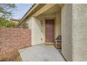 Welcoming front entrance featuring a cozy bench and decorative wall-mounted light fixture at 7413 Old Compton St, Las Vegas, NV 89166