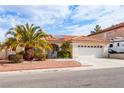 Well-maintained home featuring a two-car garage, charming walkway and lush landscaping at 9564 Summer Cypress St, Las Vegas, NV 89123