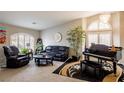 Elegant living room features a piano, comfortable seating and plenty of natural light at 9564 Summer Cypress St, Las Vegas, NV 89123