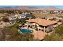 Stunning aerial view of the estate showcasing the pool, landscaping, and mountain views at 9801 Orient Express Ct, Las Vegas, NV 89145
