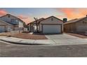 Cozy single-Gathering home featuring a wide driveway and minimal landscaping at sunset at , Las Vegas, NV 89108
