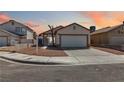 Cozy single-Gathering home featuring a wide driveway and minimal landscaping at sunset at , Las Vegas, NV 89108