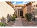 Inviting home entrance with a landscaped walkway and covered entryway at 10408 Georgetown Pl, Las Vegas, NV 89134