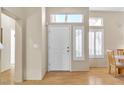 Bright entryway featuring a white front door with sidelight and clerestory window at 10408 Georgetown Pl, Las Vegas, NV 89134