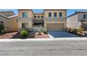 Two-story home with a two-car garage and desert landscaping at 1609 Danielle Rebecca Ave, North Las Vegas, NV 89086