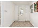 Entryway featuring a decorative glass front door, tile flooring, and a small window at 1924 S 6Th St, Las Vegas, NV 89104