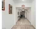 Hallway with tile flooring and decorative artwork leading to a living area with a fireplace at 1924 S 6Th St, Las Vegas, NV 89104