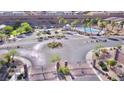 Aerial view of the community pool and surrounding landscaping showcasing community amenities at 2175 Limestone Cove Ct, Laughlin, NV 89029