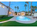 Relaxing backyard with pool, palms, and a guesthouse, offering a serene outdoor living space at 2694 Caumsett Ct, Las Vegas, NV 89117