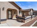 Inviting covered front entrance with decorative benches and warm stucco facade at 340 Domingo St, Pahrump, NV 89048