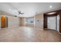 Spacious living room features bright windows, neutral paint, ceiling fan, and beautiful tile flooring at 340 Domingo St, Pahrump, NV 89048