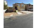 Two story home featuring an attached garage and simple desert landscaping at 4056 Blue Wildrye St, Las Vegas, NV 89122