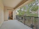 Outdoor balcony with black metal railing, offering views of the surrounding landscaping at 4615 Puglia Ln # 201, North Las Vegas, NV 89084
