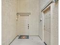 Exterior view of entrance doors with updated fixtures and a welcome mat at 4615 Puglia Ln # 201, North Las Vegas, NV 89084