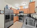 Functional kitchen with stainless steel refrigerator, gas stove, and abundant cabinetry at 4615 Puglia Ln # 201, North Las Vegas, NV 89084