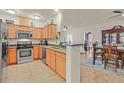 Well-lit kitchen featuring stainless steel appliances, ample cabinets, and a view into the dining area at 4615 Puglia Ln # 201, North Las Vegas, NV 89084
