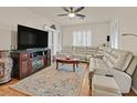 Bright living room featuring a ceiling fan, large windows, and comfortable seating at 4615 Puglia Ln # 201, North Las Vegas, NV 89084