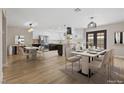 Open-concept kitchen with stainless steel appliances, a large island, and dining area with stylish furnishings at 5832 Arandas Ct, Las Vegas, NV 89103
