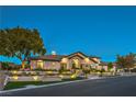 Elegant single-story home featuring meticulous landscaping with tiered planters and landscape lighting at 6 Ayden Dr, Henderson, NV 89052