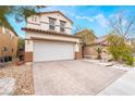 Charming two-story home featuring a paved driveway and a well-maintained front yard at 6177 W Cougar Ave, Las Vegas, NV 89139