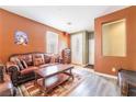 Cozy living room with a decorative rug, comfortable leather sofa and a large window at 6177 W Cougar Ave, Las Vegas, NV 89139