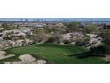 Golf course view with a sand trap and a beautiful view of the city skyline in the background at 64 Promontory Ridge Dr, Las Vegas, NV 89135