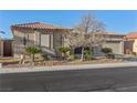 Charming single-story home with a well-maintained desert-landscaped front yard and a two-car garage at 7232 Frontier Hills Ave, Las Vegas, NV 89113
