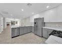 Modern kitchen featuring stainless steel appliances, sleek white cabinets, and beautiful countertops at 7803 Canoe Ln, Las Vegas, NV 89145