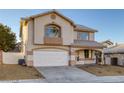 Charming two-story home with a well-maintained lawn, a two-car garage, and a cozy front porch at 793 Vortex Ave, Henderson, NV 89002