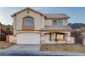Two-story home with a neutral color scheme, arched window, tile roof, and a two-car garage at 793 Vortex Ave, Henderson, NV 89002