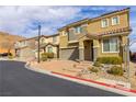 Inviting two-story home features a charming front yard, two car garage and a red tile roof at 806 Neath Ave, Las Vegas, NV 89178