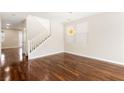 A bright living room features hardwood floors, and a modern hanging light fixture at 806 Neath Ave, Las Vegas, NV 89178