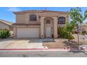Charming two-story home featuring manicured landscaping, arched entryway, and a spacious two-car garage at 8100 Artistic Heights Ct, Las Vegas, NV 89143