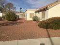 The backyard has a simple desert landscaping design, offering a low-maintenance outdoor space at 8501 Stan Crest Dr, Las Vegas, NV 89134