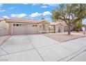 Charming home featuring a low-maintenance front yard, arched windows, and a two-car garage at 9031 W Viking Rd, Las Vegas, NV 89147