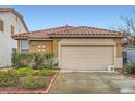 Charming single-story home features a well-manicured front yard and a two-car garage at 10011 W Cherokee Ave, Las Vegas, NV 89147