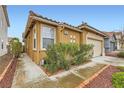 Charming single-story home features a well-manicured front yard and a two-car garage at 10011 W Cherokee Ave, Las Vegas, NV 89147