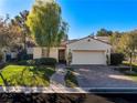 Charming single-story home with two-car garage and manicured landscaping for enhanced curb appeal at 11775 Woodbrook Ct, Las Vegas, NV 89141