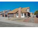 Inviting single-story home with a well-manicured yard, brick accents, and a convenient two-car garage at 1904 Roxbury Ln, Las Vegas, NV 89119