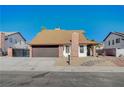 Charming single-story home showcasing a brick facade, two-car garage, and well-maintained front yard at 1904 Roxbury Ln, Las Vegas, NV 89119